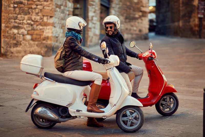 riding Vespa as a couple in summer